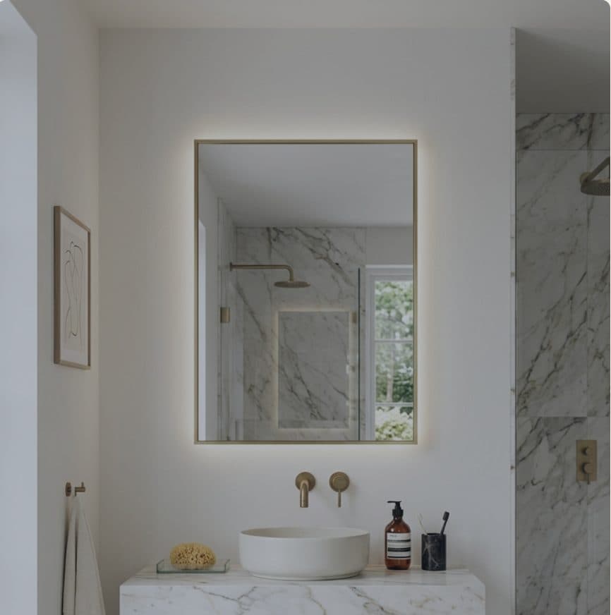 A rectangular Framed Splendor mirror in a marble bathroom